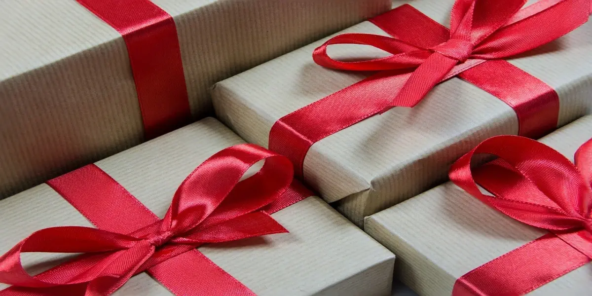 Custom holiday gift box by Artisan Colour, complete with festive ribbon and branded card, highlighting tailored packaging services for the holiday season.
